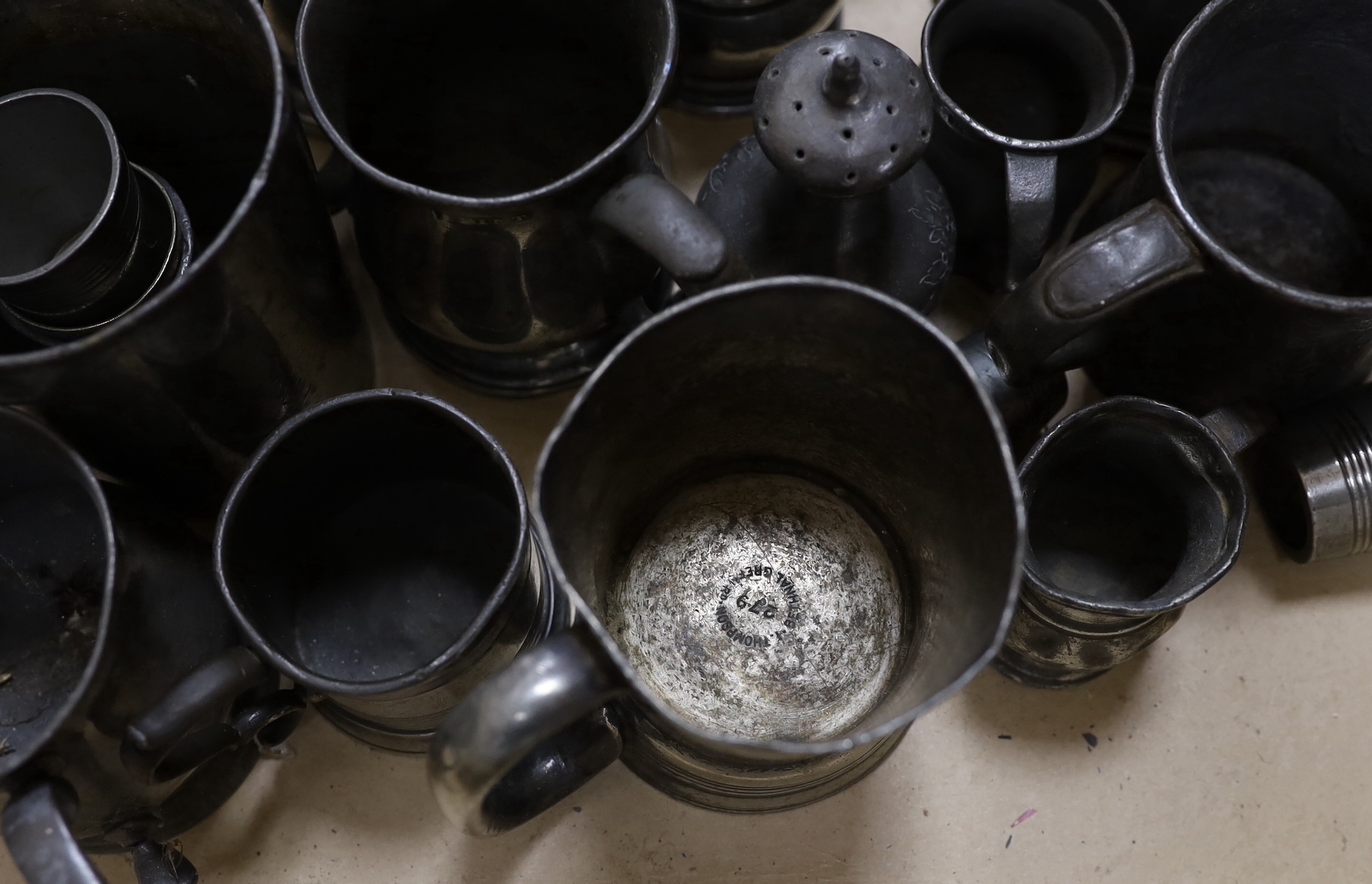 A collection of pewter mugs and measures including, The New Green Man Pub, Watford 1730, The Two Brewers, St Albans 1792 and The Lower Red Lion St Albans 1767, j tallest item 17cm high